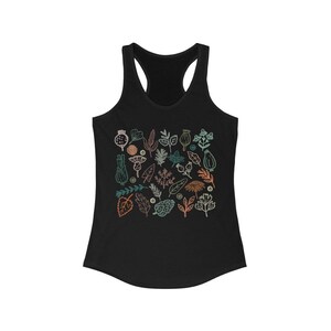 May include: Black racerback tank top with a colorful botanical print. The design features various leaves, flowers, and seed pods in shades of teal, orange, and brown. The overall style is a minimalist, nature-inspired design.