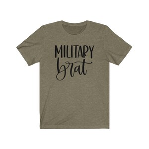 May include: A green t-shirt with the text "MILITARY brat" in black lettering.