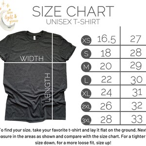 May include: A dark gray unisex t-shirt with a size chart. The chart lists sizes XS to 3XL with corresponding width and length measurements in inches. Text at the bottom advises how to measure a t-shirt for size comparison.