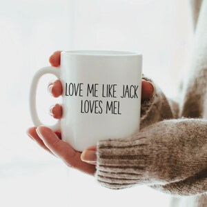 May include: White ceramic mug with black text that reads "Love me like Jack loves Mel".