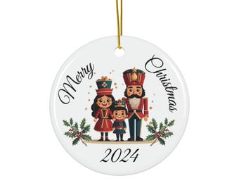 May include: White ceramic Christmas ornament with a Nutcracker family, a girl, a boy, and a man, with the text "Merry Christmas 2024" on a white background.