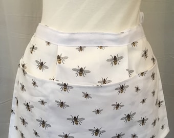 White background Busy bee multipurpose half apron with pockets.