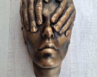 Eyes covered statue wall art sculpture painted in weathered bronze face with hands on eyes wall decoration home or office.