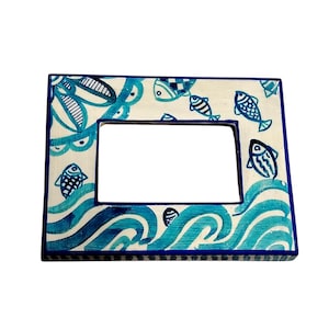 Mała drewniana ramka na zdjęcia, do powieszenia na stole lub ścianie, ręcznie malowana z sycylijskimi wzorami. Wymiary: 14 x 11 x 1,5 cm.