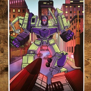 May include: A print of a robot character in a city setting. The robot is primarily green and purple, with red eyes. The background features buildings and a street with cars. The artwork has a comic book style.