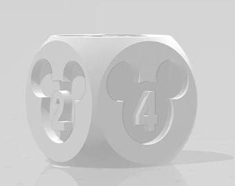 May include: White dice with Mickey Mouse ears on each side. The dice has the numbers 2 and 4 on the visible sides.
