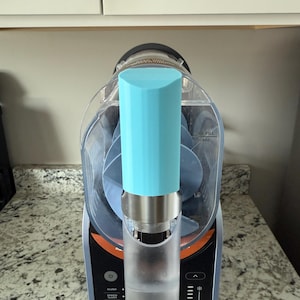 Op de afbeelding: Een close-up van een blender met een blauwe deksel en een doorzichtige container. De blender heeft een digitaal display met knoppen voor verschillende functies, waaronder "slush", "snelheid", "frappé", "smoothie", "bevroren dranken" en "sap".