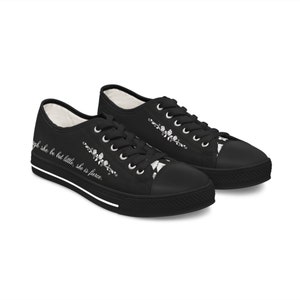 May include: Black canvas low-top trainers with white laces and a white floral design. The text "Though she be but little, she is fierce." is printed on the side of the shoes.