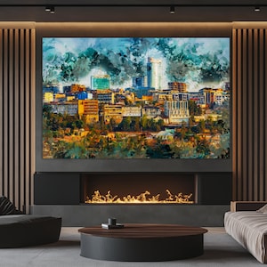 May include: Large abstract cityscape art print. The artwork features a colorful depiction of a city skyline with buildings in shades of yellow, orange, and blue. The print is mounted above a fireplace.