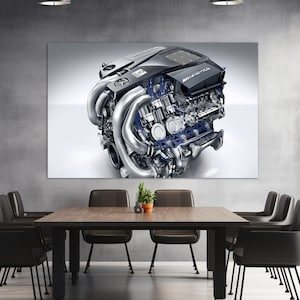May include: A close-up of a silver and black car engine with the word "AMG" on the side. The engine is shown in detail, with all of its parts visible.