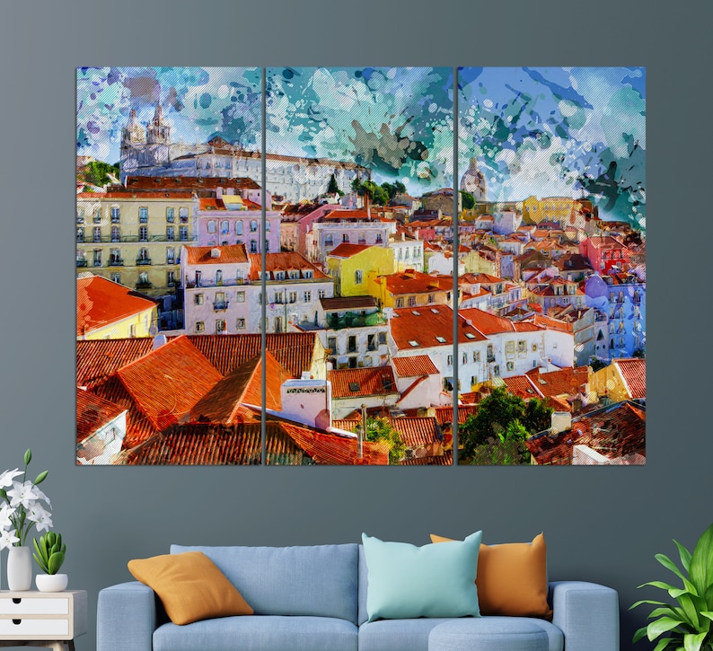 May include: A watercolor painting of a cityscape with colorful buildings and red tile roofs. The buildings are clustered together and there are trees and greenery in the foreground. The sky is a light blue with white clouds.