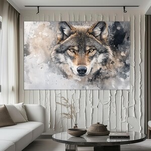 May include: A watercolor painting of a wolf's face. The wolf has a light brown and gray coat with a black nose and dark eyes. The background is a light gray with splashes of white.