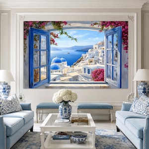 Puede incluir: Un gran cuadro de pared que muestra la vista desde una ventana abierta hacia un pueblo costero mediterráneo con edificios blancos, cúpulas azules y flores de buganvilla rosas frente a un mar y un cielo azul brillante, con contraventanas.