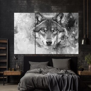 May include: A black and white watercolor painting of a wolf's face. The wolf's eyes are open and staring directly at the viewer. The background is a soft, abstract design.