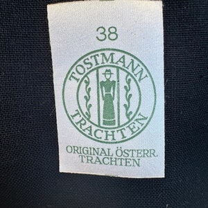 May include: A white tag with a green circle logo that says "Postmann Trachten" and the number 38. The tag also says "Original &Ouml;ster. Trachten".