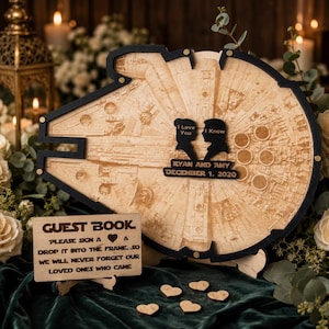 May include: A wooden guest book frame shaped like a spaceship with a black border. It features two black silhouettes with the text I Love You and I Know, plus a plaque reading RYAN AND AMY DECEMBER 1. 2020. Includes a sign with instructions.