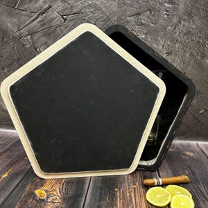 May include: A wooden box with a hexagonal lid, open to reveal a glass shot glass and a small bottle. The box is sitting on a wooden surface with a cigar and lemon slices.