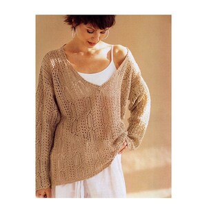 May include: A light brown crocheted sweater with a V-neck and long sleeves.