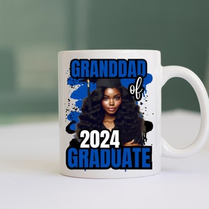 May include: White ceramic mug with a blue and white design. The design features a black woman wearing a graduation cap and gown, with the text "Granddad of 2024 Graduate".