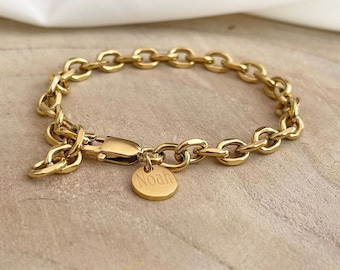 May include: A gold chain bracelet with a round charm that says "Noah".