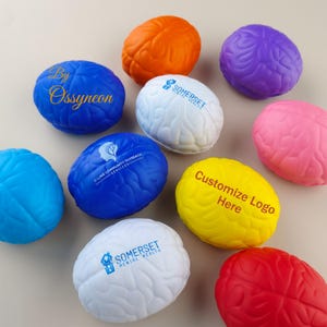 May include: Assortment of colorful brain-shaped stress balls with various logos and text printed on them, including "By Ossyneon", "C-Line Community Outreach Services", "Somerset Mental Health", and "Customize Logo Here".