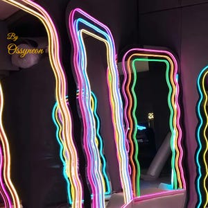 May include: Four wavy, colorful, neon-lit mirrors with a black background. The mirrors are all different heights and widths. The text "By Ossyneon" is visible in the top left corner of the image.