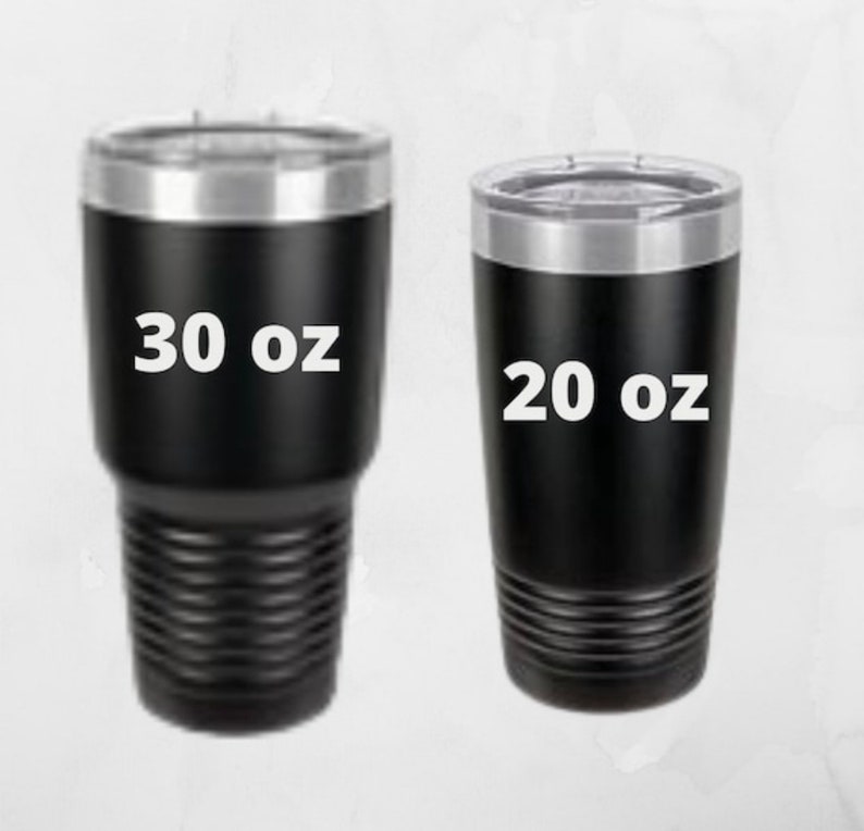 May include: Two black insulated tumblers with silver rims and lids. The larger tumbler is labeled "30 oz" and the smaller one is labeled "20 oz". Both tumblers have a textured lower body.
