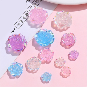 Peut inclure: Assortiment de décorations en forme de rose irisées en rose, bleu et violet. Ces fleurs décoratives sont parfaites pour ajouter une touche d'éclat à l'artisanat, aux bijoux et à d'autres projets.