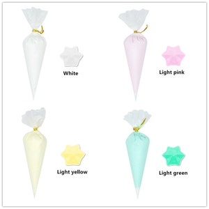 May include: Four clear plastic piping bags filled with different coloured frosting. The bags are tied with gold ribbon. The frosting colours are white, light pink, light yellow, and light green.