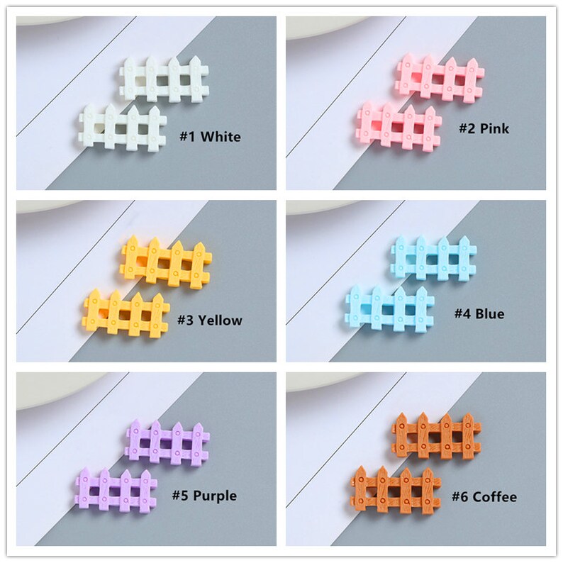 May include: Six pairs of miniature plastic fences in different colors. The fences are white, pink, yellow, blue, purple, and brown. Each pair of fences is arranged side by side with a number and color label below them. The numbers range from 1 to 6.
