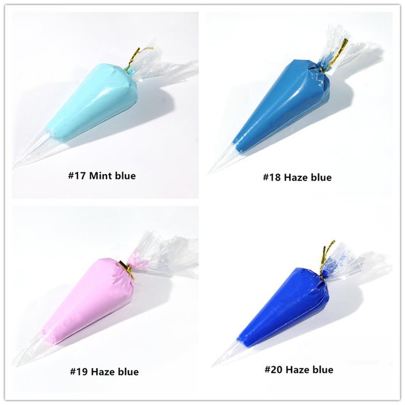 May include: Four piping bags filled with different coloured frosting. The bags are labelled with numbers and colours, including #17 Mint blue, #18 Haze blue, #19 Haze blue, and #20 Haze blue.