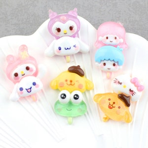 May include: Assortment of colorful cartoon character charms, each with a different design. The charms are made of resin and have a glossy finish. They are perfect for adding a touch of whimsy to jewelry, keychains, or other crafts.