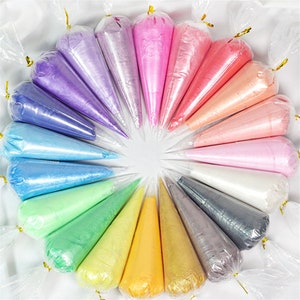 May include: A variety of colors of slime in clear plastic cones, arranged in a circle. The colors include purple, pink, orange, red, white, blue, green, yellow, and gray.