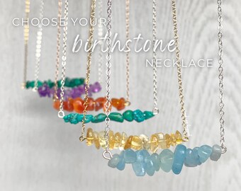 May include: A selection of birthstone necklaces with different colored gemstones. The necklaces are made with silver chains and feature a variety of birthstones, including amethyst, carnelian, turquoise, citrine, and aquamarine.  Choose your birthstone necklace.