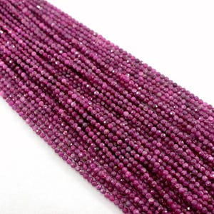 May include: A strand of ruby red gemstone beads, each bead is faceted and measures approximately 4mm in diameter.
