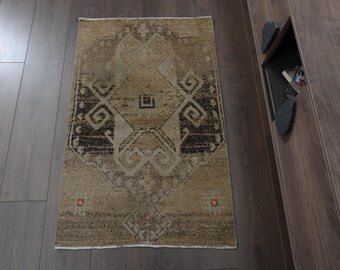 May include: A vintage-style rug with a geometric pattern in shades of brown and beige. The rug has a distressed look and is perfect for adding a touch of bohemian style to any room.