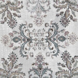 May include: A white rug with a repeating floral pattern in shades of gray, brown, and pink.