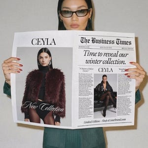 May include: A newspaper titled The Business Times featuring the CEYLA New Collection. The front page displays a photograph of a person in a dark faux fur jacket and another in a black leather coat, with the headline Time to reveal our winter collection.