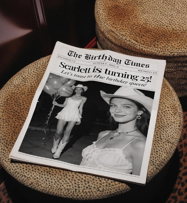 May include: A black and white newspaper titled "The Birthday Times" with the headline "Scarlett is turning 25!" and a photo of a woman in a cowboy hat. The newspaper is on a patterned surface.