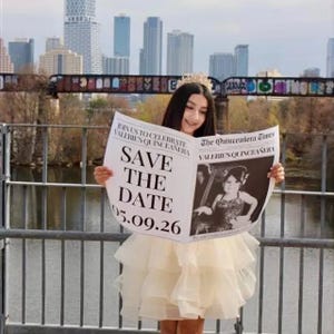 May include: A young person wearing a crown and a tiered cream-colored dress holds a newspaper with the headline "SAVE THE DATE 05.09.26" for Valerie's Quincea&ntilde;era. The background features a cityscape and a bridge.