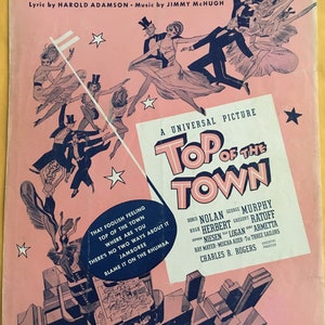 May include: Sheet music cover for "Jamboree" from the film "Top of the Town." The design features dancing figures and cityscapes on a pink background. The title and credits are displayed, with the publisher's details at the bottom.