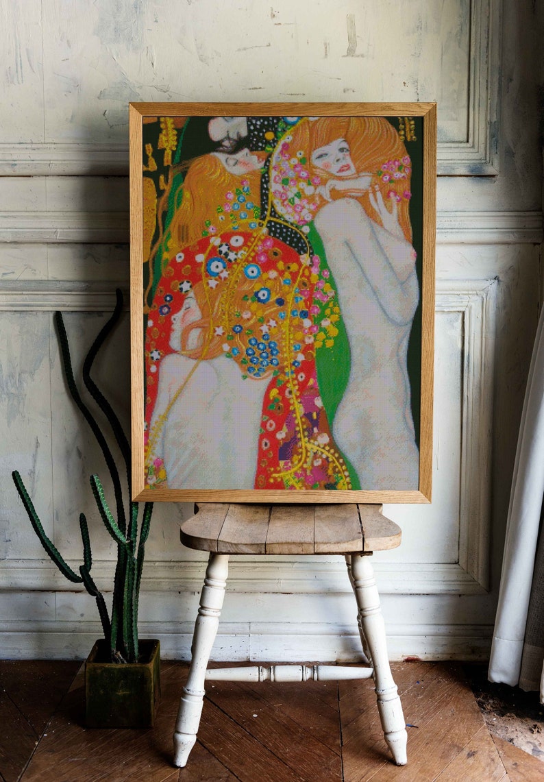 May include: A framed painting of three women with long flowing hair. The women are depicted in a colorful, abstract style with a background of flowers and swirling patterns. The painting is in a wooden frame.