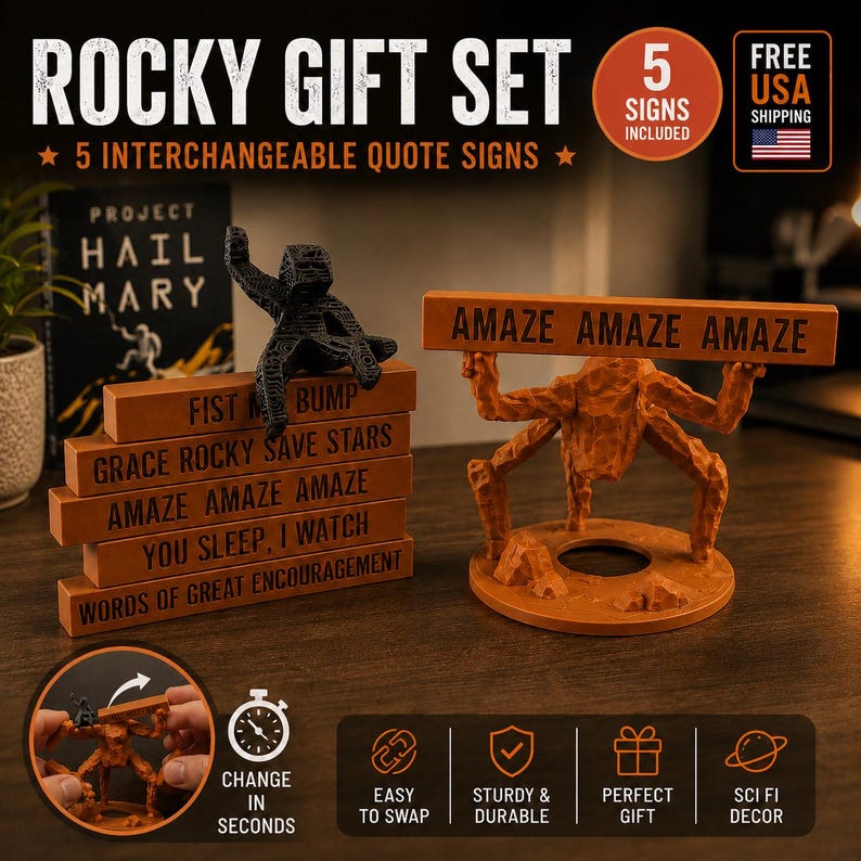 May include: A Rocky gift set featuring five interchangeable quote signs and a black textured alien figure. The set includes a brown stand with a multi-legged alien figure holding a sign that reads AMAZE AMAZE AMAZE. Other signs include FIST BUMP, GRACE ROCKY SAVE STARS, YOU SLEEP, I WATCH, and WORDS OF GREAT ENCOURAGEMENT.