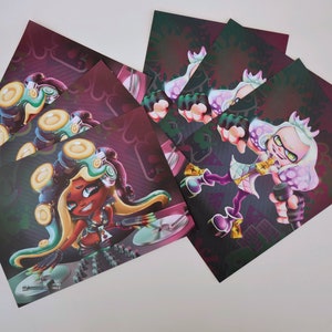 May include: A set of six printed cards featuring a cartoon character with purple hair and green eyes. The character is wearing a black and white outfit and holding a microphone. The background is a dark purple with a pattern of hearts and stars.