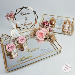 Baby pink concept islamic nikkah tray set and pink and cream flower nikkah sign for muslim wedding and engagement ceremonies. Including a big and a small nikkah golden ring tray, 2 ring boxes, 2 pink roses, a pink side flower, coffee cup set and sign