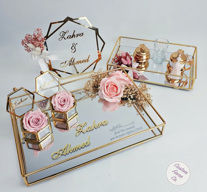 Baby pink concept islamic nikkah tray set and pink and cream flower nikkah sign for muslim wedding and engagement ceremonies. Including a big and a small nikkah golden ring tray, 2 ring boxes, 2 pink roses, a pink side flower, coffee cup set and sign