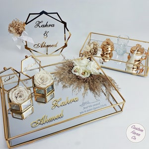 Cream concept islamic nikkah tray set and pink and cream flower nikkah sign for muslim wedding and engagement ceremonies. Including a big and a small nikkah golden ring tray, 2 ring boxes, 2 cream roses, a cream side flower, coffee cup set and sign