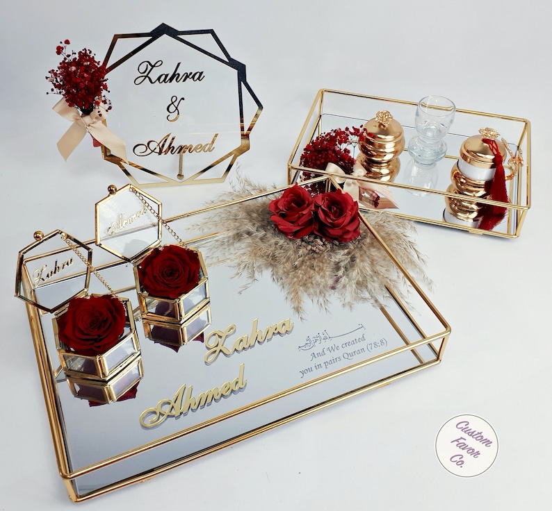 Red concept islamic nikkah tray set and red and cream flower nikkah sign for muslim wedding and engagement ceremonies. Including a big and a small nikkah golden ring tray, 2 ring boxes, 2 red roses, a red side flower, coffee cup set & wedding sign
