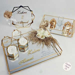 White concept islamic nikkah tray set and white and cream flower nikkah sign for muslim wedding and engagement ceremonies. Including a big and a small nikkah golden ring tray, 2 ring boxes, 2 white roses, a creamy side flower, coffee cup set and sign