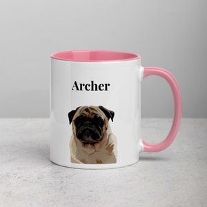 May include: White ceramic mug with a pink rim and handle. The mug features a cartoon illustration of a pug with the name "Archer" printed in black text.